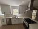 Modern kitchen with white cabinets, subway tile backsplash, and stainless steel appliances at 1789 Springhouse Ct, Lawrenceville, GA 30043