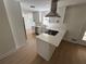 Modern kitchen features stainless steel appliances, bright white cabinetry and a quartz countertop island at 1789 Springhouse Ct, Lawrenceville, GA 30043