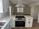 Bright kitchen features white cabinets, stainless steel appliances, and quartz countertops at 1789 Springhouse Ct, Lawrenceville, GA 30043