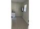 Laundry room showcasing sink, cabinet, and patterned tile floor at 1789 Springhouse Ct, Lawrenceville, GA 30043
