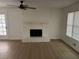 Living area with freshly painted brick fireplace, new flooring and views to screened porch at 1789 Springhouse Ct, Lawrenceville, GA 30043