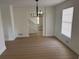 Living room view showcasing new flooring, modern lighting, neutral walls and ample natural light at 1789 Springhouse Ct, Lawrenceville, GA 30043