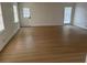 Spacious and bright living room featuring new flooring, white walls and lots of natural light at 1789 Springhouse Ct, Lawrenceville, GA 30043