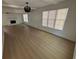 Bright living room with new flooring, modern lighting, and a cozy painted brick fireplace at 1789 Springhouse Ct, Lawrenceville, GA 30043