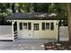 Versatile outbuilding featuring painted horizontal siding, decorative shutters, and a charming trellis fence surround at 1789 Springhouse Ct, Lawrenceville, GA 30043