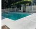 Inviting swimming pool surrounded by a charming lattice fence and white concrete for summer fun at 1789 Springhouse Ct, Lawrenceville, GA 30043