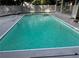 Inviting swimming pool surrounded by a charming lattice fence and white concrete for summer fun at 1789 Springhouse Ct, Lawrenceville, GA 30043