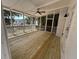 Inviting screened porch features new wood flooring, ceiling fan and backyard views at 1789 Springhouse Ct, Lawrenceville, GA 30043