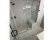 Luxurious shower featuring marble walls, a built-in bench, and modern fixtures providing a spa-like experience at 1789 Springhouse Ct, Lawrenceville, GA 30043