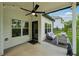 Covered back porch with ceiling fan, lights, and modern outdoor furniture at 236 Lakestone Pkwy, Woodstock, GA 30188