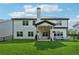 Spacious backyard with a covered porch and black metal fence at 236 Lakestone Pkwy, Woodstock, GA 30188