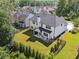 Beautifully landscaped backyard with a covered patio, perfect for outdoor relaxation and entertainment at 236 Lakestone Pkwy, Woodstock, GA 30188