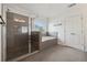 Modern bathroom with glass shower, garden tub, and double-door closet at 236 Lakestone Pkwy, Woodstock, GA 30188