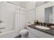 Clean bathroom with a shower-tub, marble countertop, and modern faucet at 236 Lakestone Pkwy, Woodstock, GA 30188