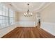 Elegant dining room with a chandelier, hardwood floors, and wainscoting at 236 Lakestone Pkwy, Woodstock, GA 30188