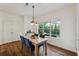 Charming dining room with wood floors, natural light, and a modern light fixture at 236 Lakestone Pkwy, Woodstock, GA 30188