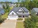 Aerial view of a two-story home with stone accents, a covered porch, and a driveway at 236 Lakestone Pkwy, Woodstock, GA 30188