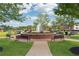 Beautiful park fountain with blooming flowers and surrounding park benches at 236 Lakestone Pkwy, Woodstock, GA 30188