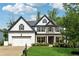 Charming two-story home featuring stone accents, a manicured lawn, and a two-car garage at 236 Lakestone Pkwy, Woodstock, GA 30188
