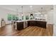 Modern kitchen featuring an island, stainless steel appliances, and dark cabinets at 236 Lakestone Pkwy, Woodstock, GA 30188