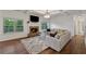Inviting living room with a brick fireplace, large windows, and a decorative rug at 236 Lakestone Pkwy, Woodstock, GA 30188