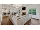 Bright and airy living room with a cozy fireplace, coffered ceilings, and hardwood flooring at 236 Lakestone Pkwy, Woodstock, GA 30188
