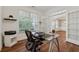 Well-lit office with hardwood floors, a glass desk, and French door access at 236 Lakestone Pkwy, Woodstock, GA 30188