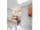 Bright bathroom featuring a skylight, vanity, and soaking tub at 269 Powder Mill Dr, Dallas, GA 30157