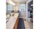 Bright bathroom features a spacious vanity, patterned rug, and shelving for ample storage at 269 Powder Mill Dr, Dallas, GA 30157