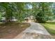 Charming home featuring a long driveway and a welcoming front yard with mature trees at 269 Powder Mill Dr, Dallas, GA 30157