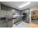 Well-equipped kitchen with stainless steel appliances and gray cabinets adjoining a cozy living room at 269 Powder Mill Dr, Dallas, GA 30157
