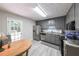 Well-lit kitchen with stainless steel appliances, gray cabinets, and light wood-style vinyl flooring at 269 Powder Mill Dr, Dallas, GA 30157