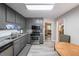 Charming kitchen with gray cabinets, stainless appliances, and a cozy dining area at 269 Powder Mill Dr, Dallas, GA 30157