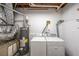 Functional laundry area featuring a washer, dryer, and water heater to efficiently handle laundry needs at 269 Powder Mill Dr, Dallas, GA 30157