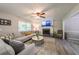 Spacious living room with a fireplace, comfortable sectional sofa, and abundant natural light at 269 Powder Mill Dr, Dallas, GA 30157