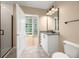 Bright bathroom featuring a white vanity, granite countertop, and glass-enclosed shower at 923 Peachtree Ne St # 932, Atlanta, GA 30309