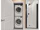 Bathroom featuring a stackable washer/dryer unit and a white subway tile shower at 923 Peachtree Ne St # 932, Atlanta, GA 30309