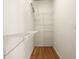 Walk-in closet complete with custom shelving and hardwood floors at 923 Peachtree Ne St # 932, Atlanta, GA 30309