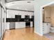 Modern kitchen featuring stainless steel appliances, black backsplash, and access to a bathroom at 923 Peachtree Ne St # 932, Atlanta, GA 30309