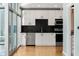 Modern kitchen featuring stainless steel appliances, black backsplash, and floor-to-ceiling window at 923 Peachtree Ne St # 932, Atlanta, GA 30309