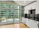 Well-appointed kitchen with modern finishes, with balcony access and city views at 923 Peachtree Ne St # 932, Atlanta, GA 30309
