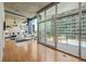 Open-concept living room with floor-to-ceiling windows, hardwood floors, and views of the city at 923 Peachtree Ne St # 932, Atlanta, GA 30309