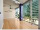 Bright living room with hardwood floors, concrete ceilings, and large windows offering city views at 923 Peachtree Ne St # 932, Atlanta, GA 30309