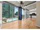 Spacious living room with hardwood floors, concrete ceilings, and access to building pool and city views at 923 Peachtree Ne St # 932, Atlanta, GA 30309