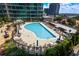 Community pool deck with lounge chairs and umbrellas at 923 Peachtree Ne St # 932, Atlanta, GA 30309
