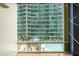 Floor-to-ceiling window featuring views of the building pool and manicured outdoor space at 923 Peachtree Ne St # 932, Atlanta, GA 30309
