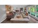 Bright living room featuring hardwood floors, large windows, and comfortable seating with stylish decor at 2994 Baker Ridge Nw Dr, Atlanta, GA 30318