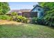 Home's backyard and back exterior featuring a screened-in porch and mature trees at 9055 Green Valley Ct, Douglasville, GA 30134