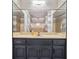 This bathroom vanity features sleek countertops, dark wood cabinetry and modern fixtures at 9055 Green Valley Ct, Douglasville, GA 30134