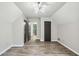 Bedroom with modern light fixture, two closets, and wood floor at 9055 Green Valley Ct, Douglasville, GA 30134